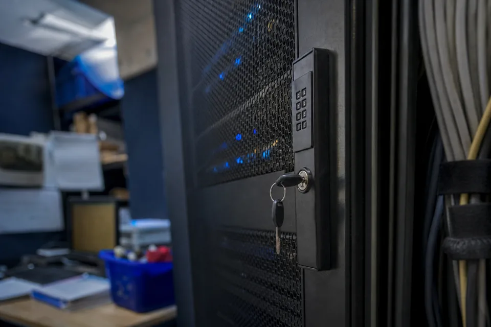 Locked server cabinet with a keypad and blue status lights